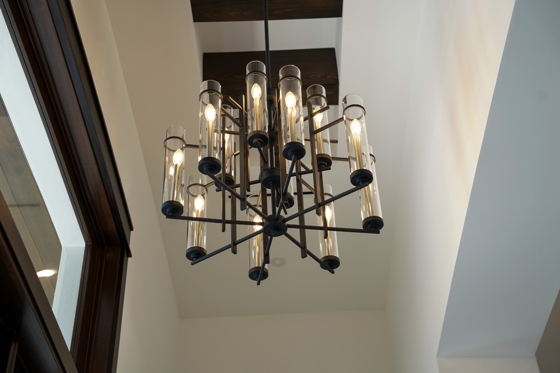 Large multi-arm chandelier installed in a two-story home foyer