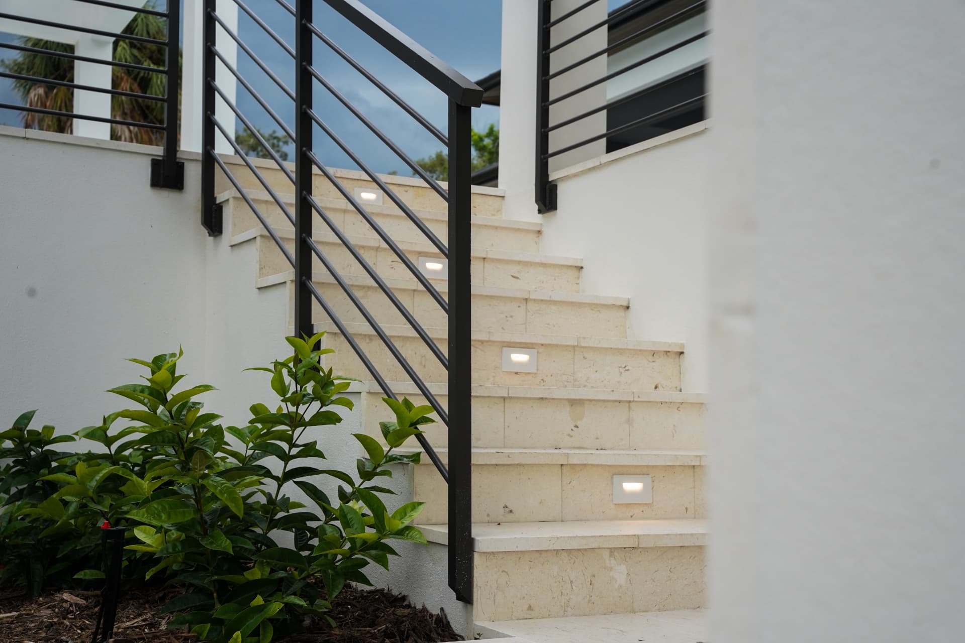 Recessed LED step lights installed in exterior stone stairs of a modern Sarasota home